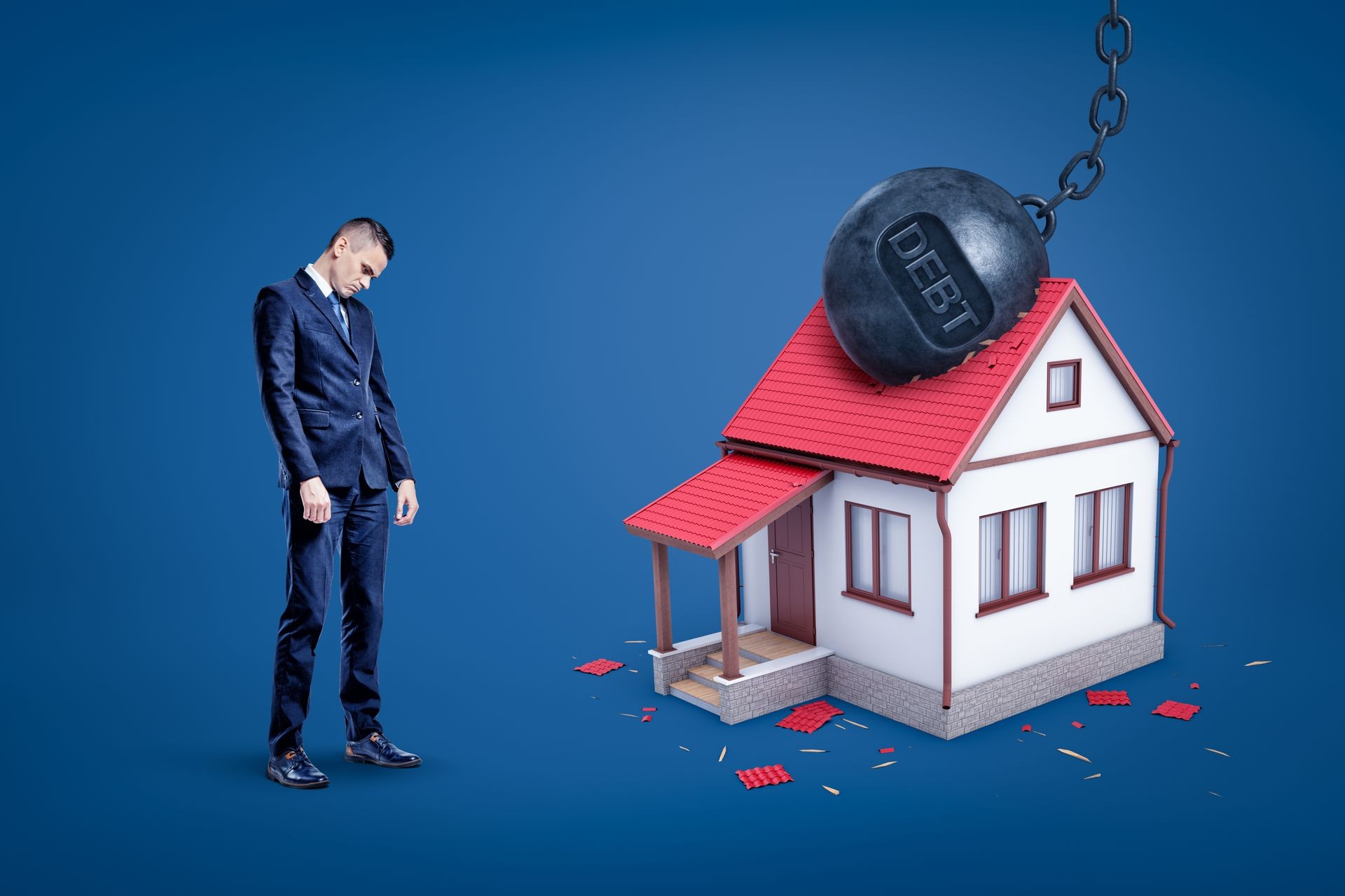 Sad businessman and metal chained ball with 'DEBT' sign breaking white private house. Financial risks. Business and commerce. Banking and finance.